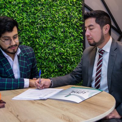 Beautiful young Latin woman driving her brand new car and showing her thumb up